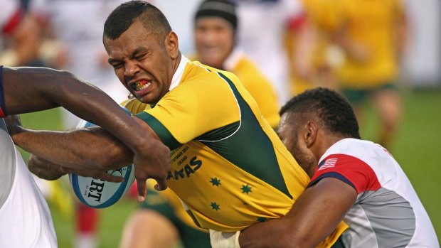 Tough going: Kurtley Beale is tackled by the US defence.