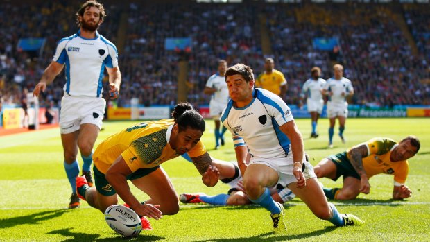 Joe Tomane scores a try during the 2015 Rugby World Cup Pool A match between Australia and Uruguay at Villa Park.