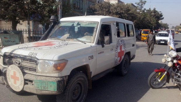 Taliban fighters drive a vehicle seized from the Red Cross in Kunduz.