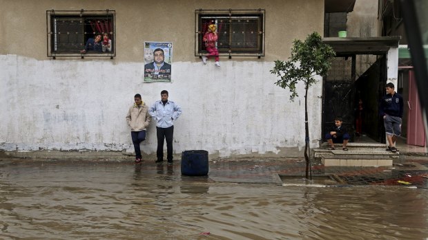 Water-logged: People in front of their house during heavy rain in Gaza City.
