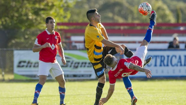 Canberra FC's Thomas James battles for possession. 