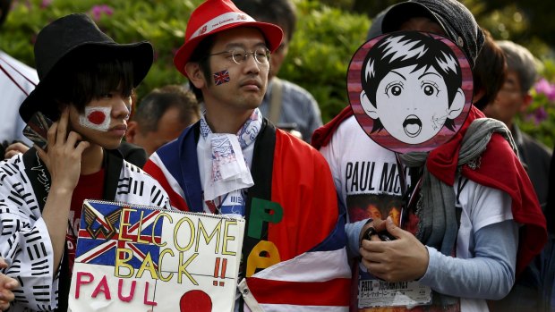Fans wait for the arrival of Paul McCartney before his gig at the Nippon Budokan Hall.