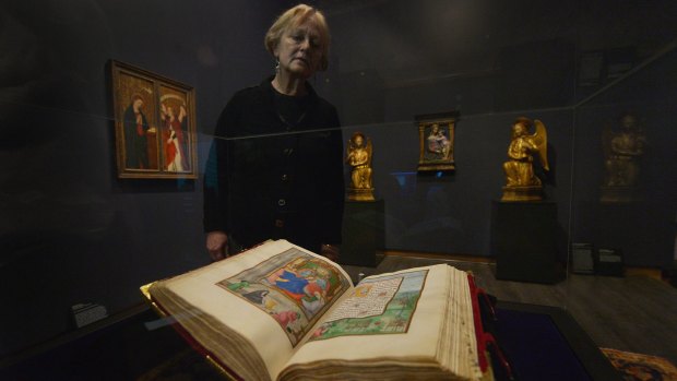 Erica Persak with the  Rothschild Prayerbook. Bought at auction for $15.5 million by Kerry Stokes, it's now on display at the Ian Potter Museum.