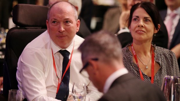 Gary Warren and his wife Michelle listen as Treasurer Scott Morrison shares their story.