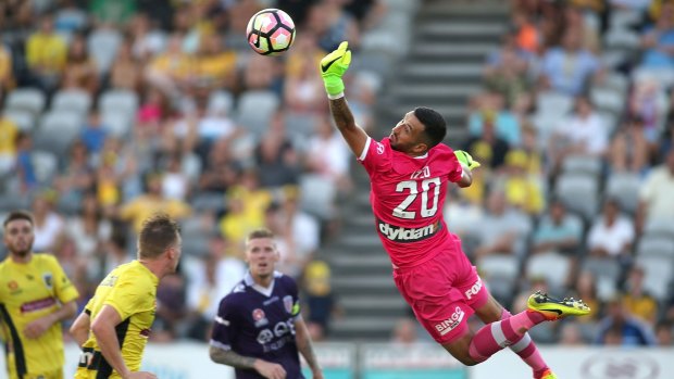 Flying high: Paul Izzo saves against Perth Glory at Central Coast Stadium.