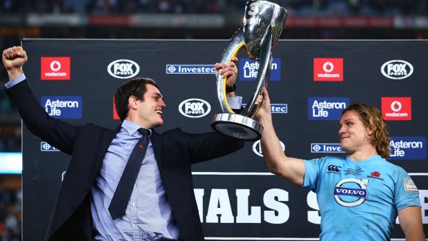 High point: Dave Dennis and Michael Hooper of the Waratahs lift the trophy after winning the Super Rugby Grand Final against the Crusaders.