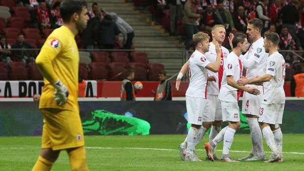 Poland players celebrate after scoring a goal against Gibraltar.