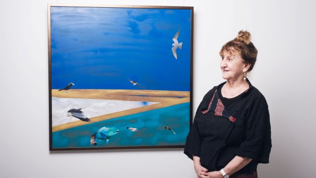Artist Jinx Nolan with one of her abstracted landscapes on show in Sydney.