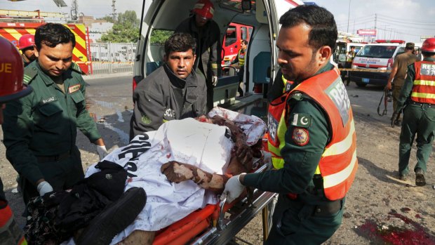 Pakistani rescue workers remove a body from the site of the deadly bombing.