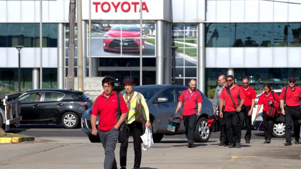 Staff leaving  the Toyota factory in Altona after hearing that the plant would close in October. 