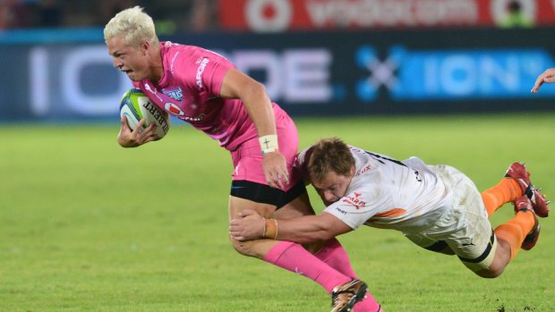 Roped in: Tian Schoeman of the Bulls tackled by Torsten van Jaarsveld of the Cheetahs.