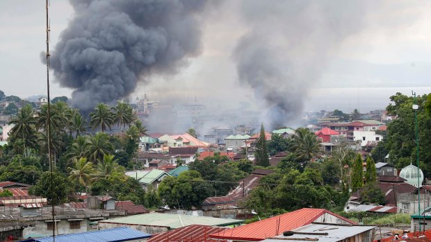 Fires rage following airstrikes by the Philippines Air Force in Marawi city on Saturday.