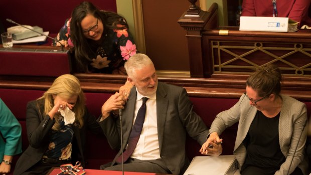 Reason Party MP Fiona Patten weeps and embraces Labor's Gavin Jennings as Jaclyn Symes takes his hand after the euthanasia bill passed Victorian Parliament's upper house. 