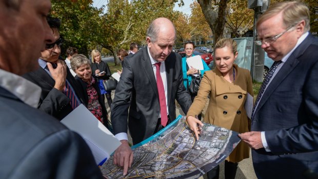 Planning Minister Richard Wynne examines maps of Fishermans Bend.