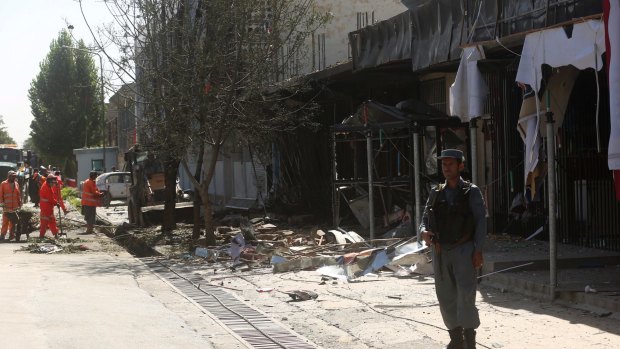 Municipality workers clean up at the site of Monday's suicide attack in Kabul.