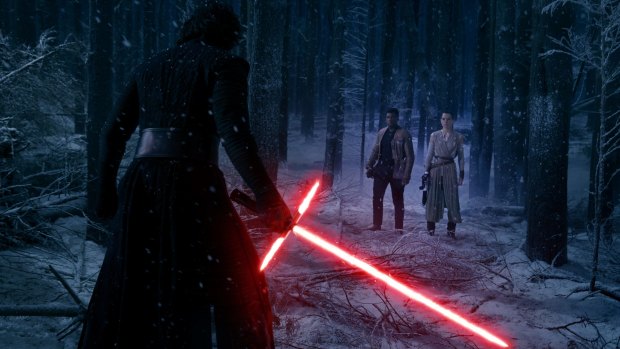 Kylo Ren (Adam Driver) confronts Finn (John Boyega) and Rey (Daisy Ridley) in Star Wars: The Force Awakens.