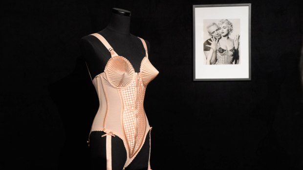 Madonna's famous corset and a photo of the singer with Jean Paul Gaultier at the National Gallery of Victoria exhibition in 2015. 