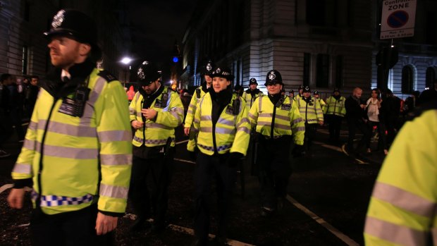Police officers deploy to their positions ahead of New Year's Eve celebrations in London.