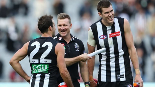 Nathan Buckley enjoying a laugh with Steele Sidebottom and Mason Cox after the win.