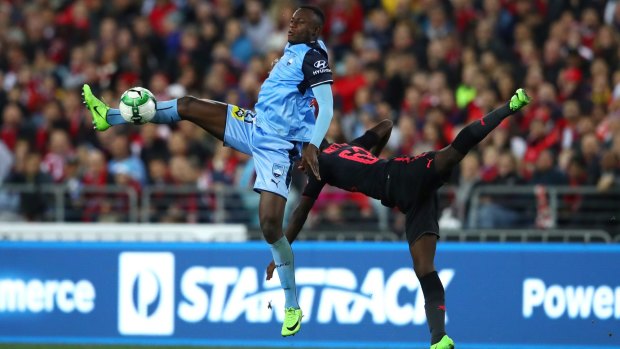 Charles Lokolingoy of Sydney FC and Eddie Nketiah of Arsenal are locked in a contest.