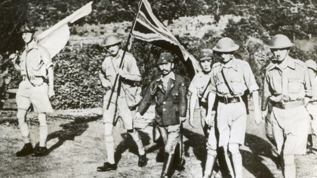 Fall of Singapore: Staff Officer Sugita conducts Lt. General Arthur Percival (right) and other British officers to the Ford factory at Bukit Timah where the surrender took place. 