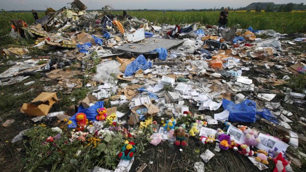 In tribute: Flowers and mementos left by local residents at the MH17 crash site.