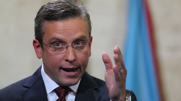 Governor Alejandro Garcia Padilla said he would seek to work out a deal with creditors while urging Washington to pass a law allowing the island to enter a special form of bankruptcy and discharge some of its debts.