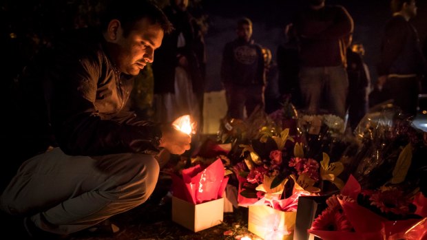 Waqas Haider participates in the candlelight vigil.