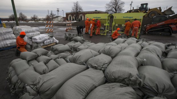 Braced: Emergency workers have filled thousands of sandbags in anticipation of water from melting snow.