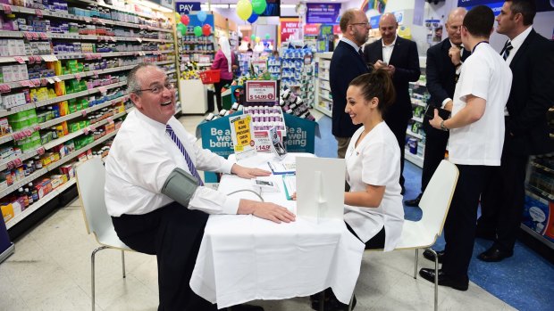 Labor MP Walt Secord gets a free health check at a pharmacy in Wetherill Park.