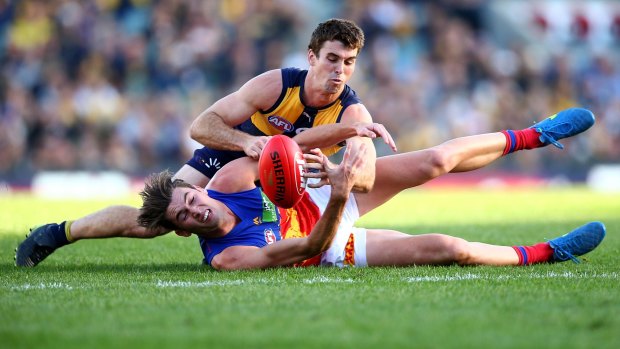 Down and out: West Coast's Jamie Cripps battles Jacob Allison for possession.