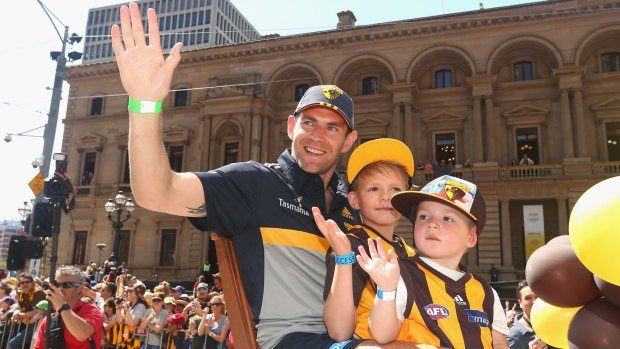 Hawthorn captain Luke Hodge waves to the crowd during Friday's grand final parade.
