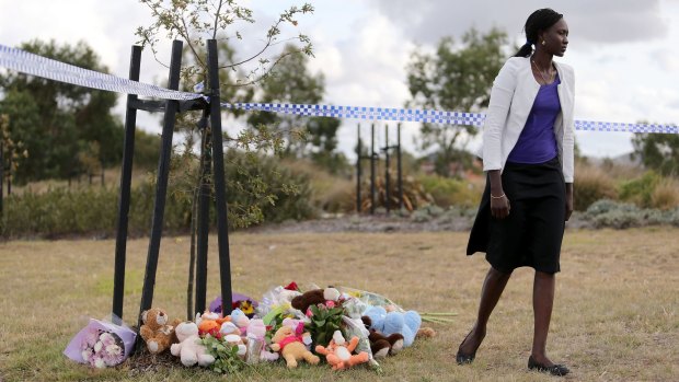 A member of the Sudanese community pays tribute at the scene in Wyndham Vale where three children died.