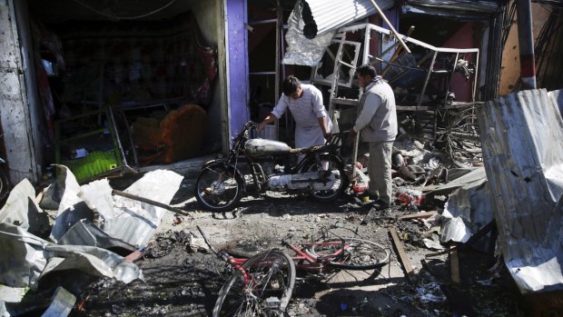 Men at the site of Monday's suicide attack in Kabul.