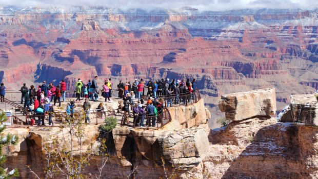 Tourists admire the Grand Canyon.