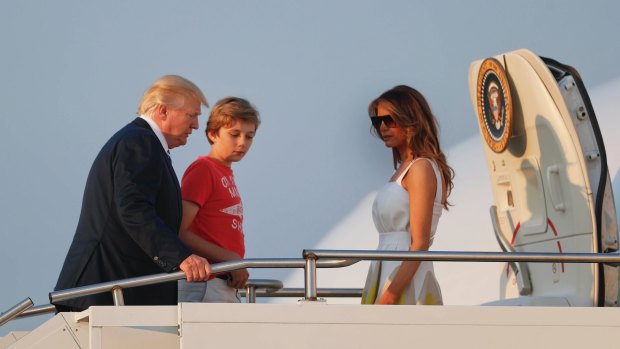 President Donald Trump, first lady Melania Trump and son Barron Trump board Air Force One at Morristown Municipal Airport on Sunday, August 20, 2017.