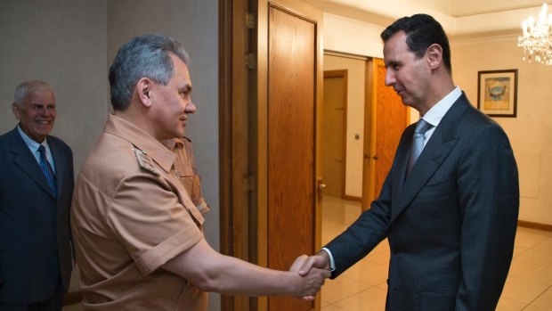 Syrian President Bashar al-Assad, right, shakes hands with Russian Defence Minister Sergei Shoigu in Damascus in June.