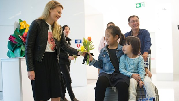 The first customers to disembark from the Capital Express were greeted with flowers