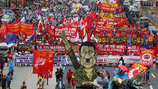 Thousands march on the Philippine parliament with an effigy of President Rodrigo Duterte to demand that he scrap martial law in Mindanao and deliver on promises he made in his first state of the nation address last year.