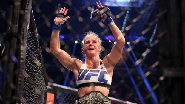 Holly Holm celebrates victory over Ronda Rousey during UFC 193.