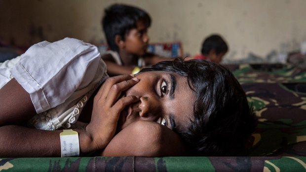 A Rohingya girl rests in a temporary shelter  in Kuala Langsa, Indonesia.