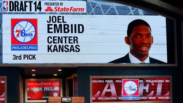Unseen potential: A video screen shows the selection of Joel Embiid of Kansas as the #3 overall pick in the first round by the Philadelphia 76ers during the 2014 NBA Draft at Barclays Center on June 26, 2014.
