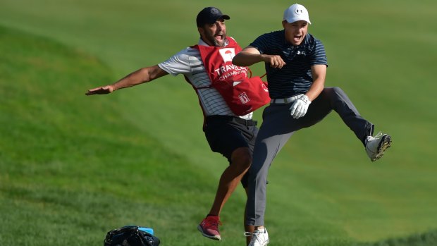 Master stroke: Jordan Spieth celebrates with caddie Michael Greller after Spieth holed a bunker shot on a playoff hole to win the Travelers Championship.