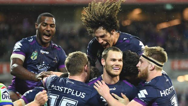 Cheyse Blair of the Storm is congratulated by team mates after scoring a try during the NRL Preliminary Final.
