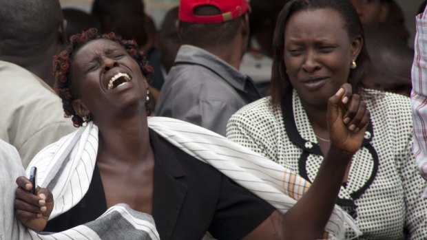 A woman cries after viewing the body of a relative killed in Thursday's attack.