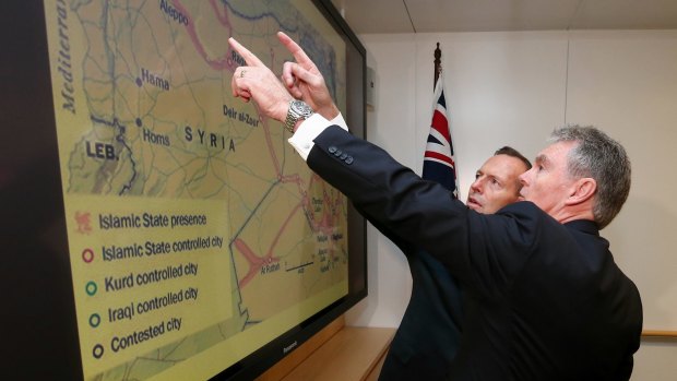 ASIO director-general Duncan Lewis briefs then prime minister Tony Abbott on Islamic State earlier this year.