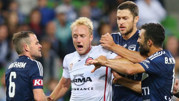 Mitch Nichols of the Wanderers is held back by Leigh Broxham and Matthieu Delpierre of the Victory while arguing with Fahid Ben Khalfallah.