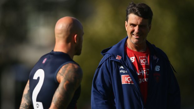 Coach Paul Roos, who has sold his bayside home, talks to captain Nathan Jones at training.