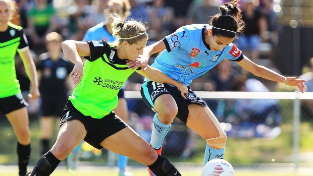 Canberra United defender Ellie Brush (left) challenges Sydney FC's Leena Khamis for the ball in last week's W-League game in Sydney.