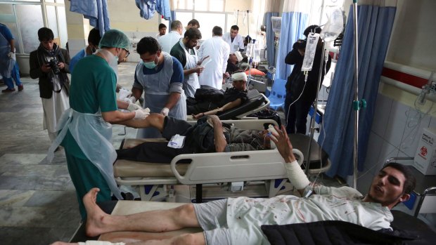 Injured men receive treatment at a hospital after a suicide attack in Kabul on January 27.